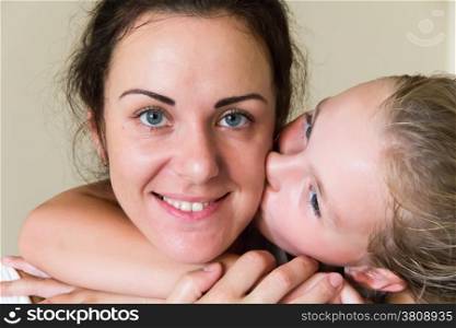 Photo of kissing mother and daughter
