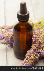 photo of lavender essential oil over wooden table