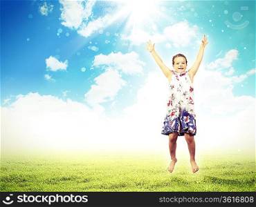Photo of little girl jumping and raising hands against nature background