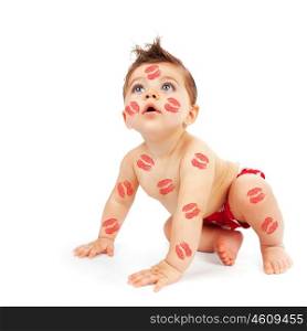 Photo of lovely baby boy try to get up, portrait of cute child isolated on white background, little adorable kid covered red lipstick kisses, nice Cupid for Valentines day, love and care concept