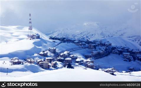 Photo of luxury winter resort, Christmas and New Year holiday, countryside lodges covered with white snow, Faraya mountains in Lebanon, cold frosty weather, snowy mountain landscape