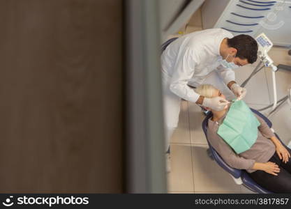 photo of male dentist and his patient in a dentist office