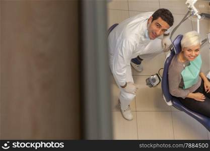 photo of male dentist and his patient in a dentist office