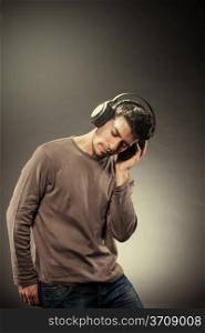 Photo of man who is listening to music while wearing headphones