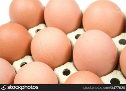 Photo of many brown eggs in a cardboard