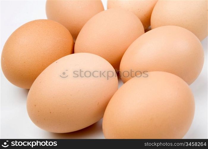 Photo of many brown hen eggs isolated over white