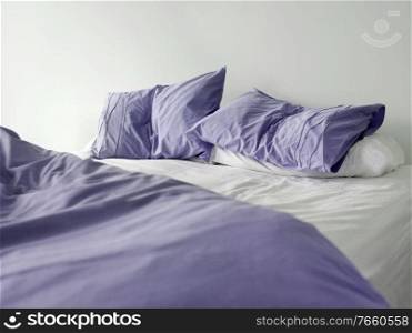 Photo of messy purple bed