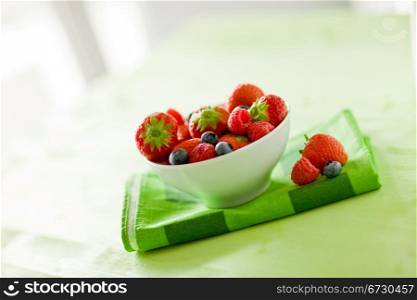 photo of mixed fresh berries on green table by day light