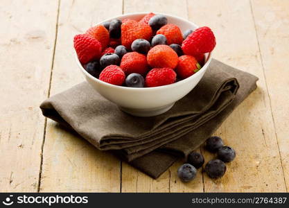 photo of mixed fresh berries on wooden table