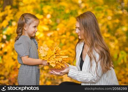 Photo of mom with daughter and yellow leaves.. A large photo of mom and daughter in autumn with yellow leaves 3376.