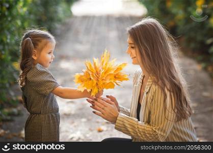 Photo of mom with daughter and yellow leaves.. A large photo of mom and daughter in autumn with yellow leaves 3377.
