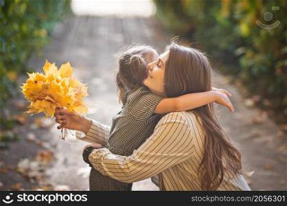 Photo of mom with daughter and yellow leaves.. A large photo of mom and daughter in autumn with yellow leaves 3378.