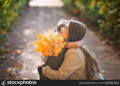 Photo of mom with daughter and yellow leaves.. A large photo of mom and daughter in autumn with yellow leaves 3379.