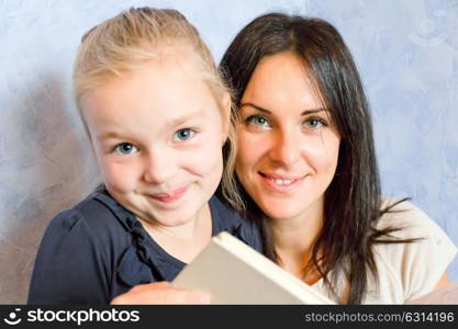 Photo of mother and daughter are reading a book