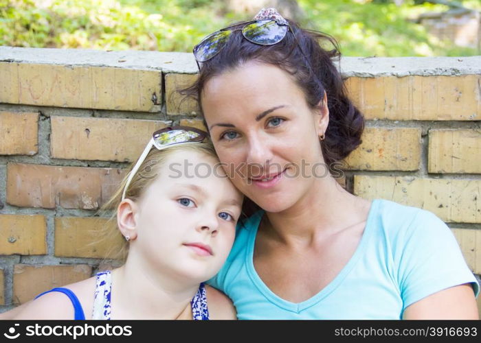 Photo of mother and daughter in summer with sunglass
