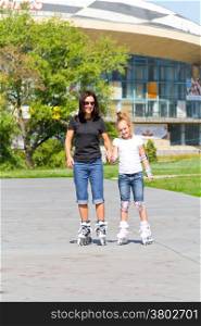 Photo of mother and daughter on roller skates in summer