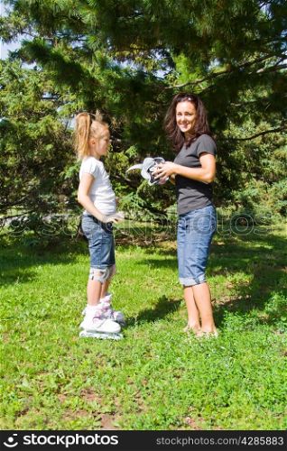 Photo of mother and daughter playing in summer