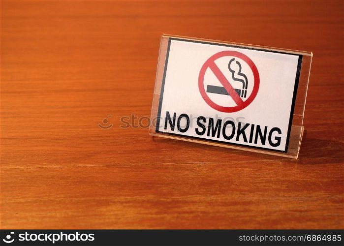 photo of no smoking sign on wooden table