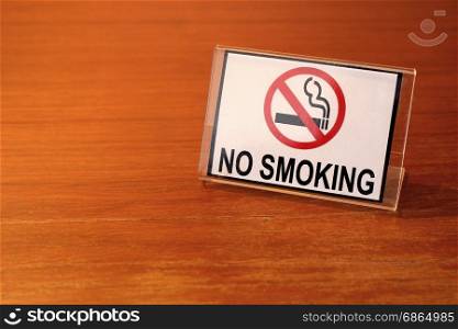 photo of no smoking sign on wooden table