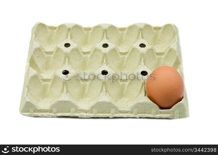 Photo of one brown egg in a cardboard isolated over white