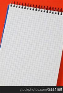 Photo of one notebook in blank with blue squares isolated over red
