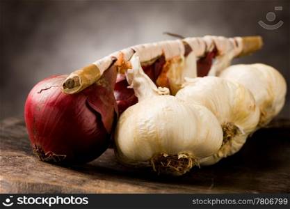 photo of onion and garlic on wooden table