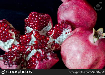 Photo of open pomegranate on black background