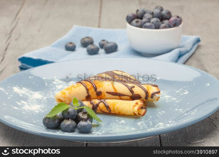Photo of pancake with blueberry over wooden table