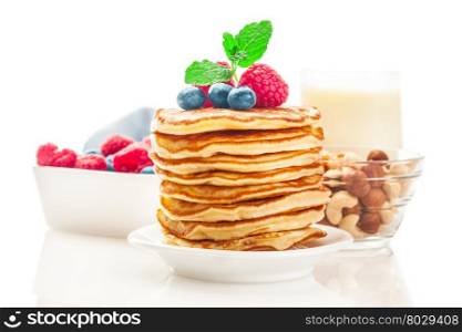 Photo of pancakes with berries over white isolated background