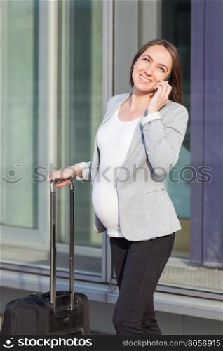 Photo of pregnant business woman talking on phone