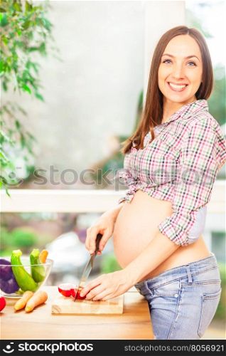 Photo of pregnant woman cooking at home