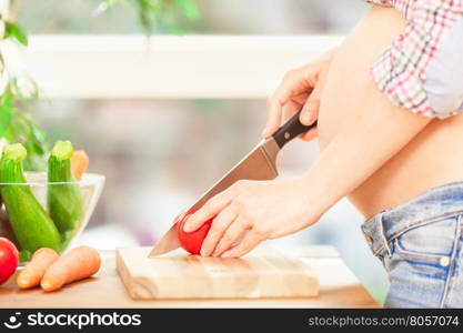 Photo of pregnant woman cooking at home