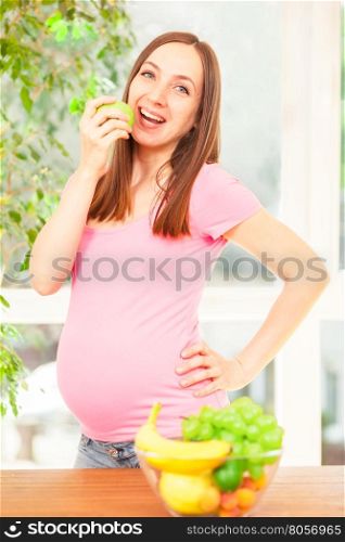Photo of pregnant woman eating an apple