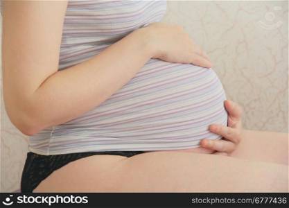 Photo of pregnant woman in striped cloth
