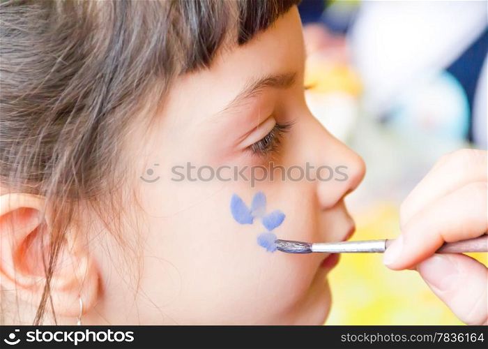 Photo of preschooler with flower on the cheek