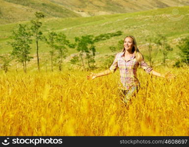 Photo of pretty woman running on golden wheat field, beautiful young lady having fun outdoors, happy smiling girl enjoying freedom on crop meadow, grain harvest season, autumn landscape&#xA;
