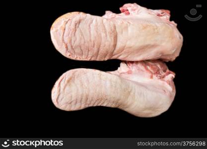 Photo of raw pork tongue on black background