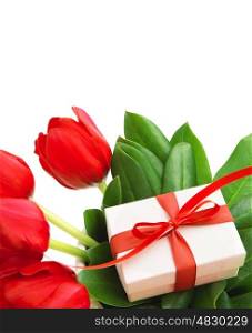 Photo of red tulips flowers and small white gift box on fresh green leaves, romantic still life for happy mothers day isolated on white background, festive present, birthday holiday, cute surprise