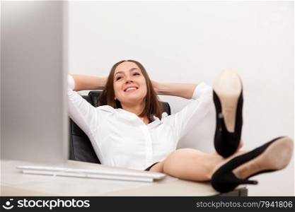 Photo of relaxed businesswoman with legs at the desk