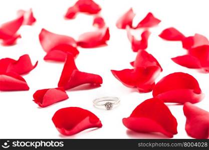 Photo of ring over red petals isolated