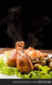 photo of roasted smoking hot chicken with mushrooms and lettuce