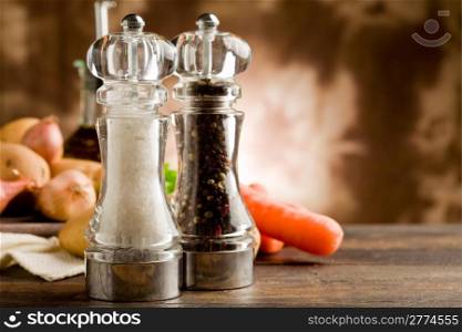 photo of salt and pepper mill with ingredients arround on wooden table