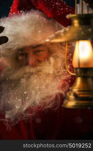 Photo of Santa Claus outdoors under blowing wind and falling snow and looking at camera