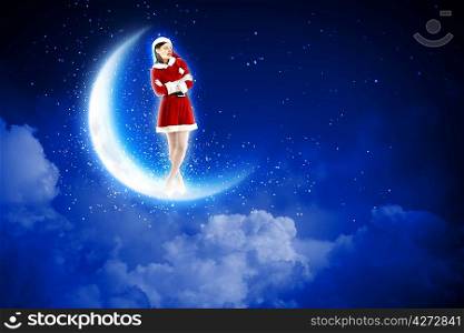 photo of santa girl sitting on the moon