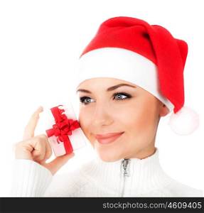 Photo of Santa girl with gift box, pretty female wearing red Christmas hat, close up face portrait, happy woman holding present isolated on white background, Xmas shopping, winter holiday celebration