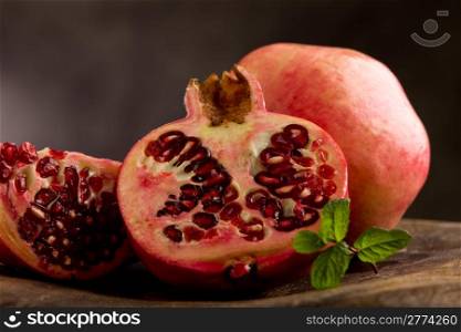 photo of sliced pomgranate in poor art style in front of rural background