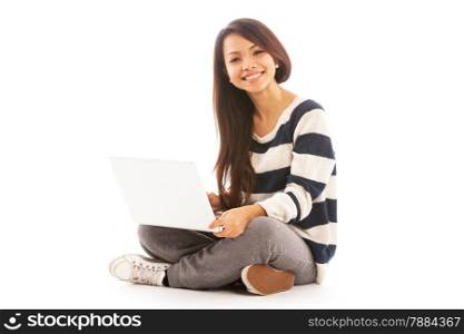 Photo of smiling asian girl sitting with notebook over white isolated background
