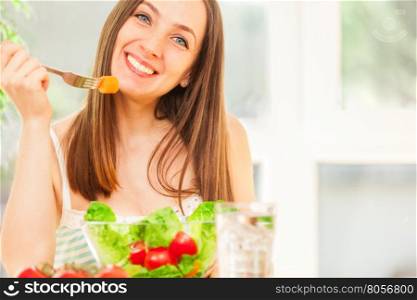 Photo of smiling caucasian woman eating salad