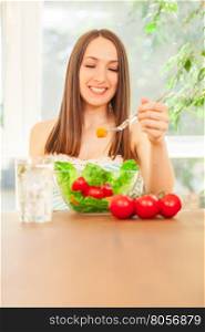 Photo of smiling caucasian woman eating salad