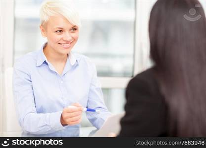 photo of smiling female manager doing a job interview